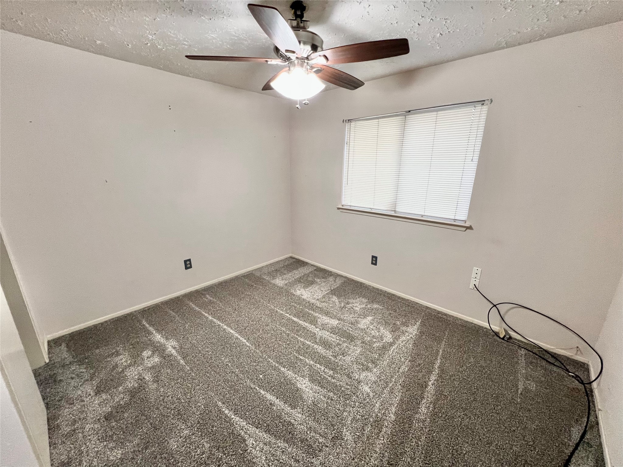 104 Trail Ride Road Angleton, TX 77515 - Photo 13 of 26 a view of a room with a ceiling fan and a rug