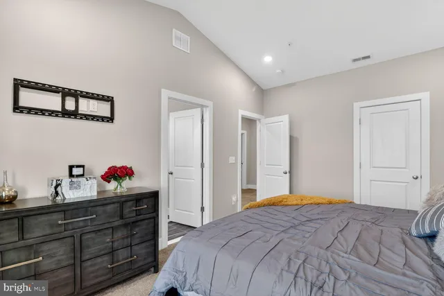 a bedroom with a bed and a dresser