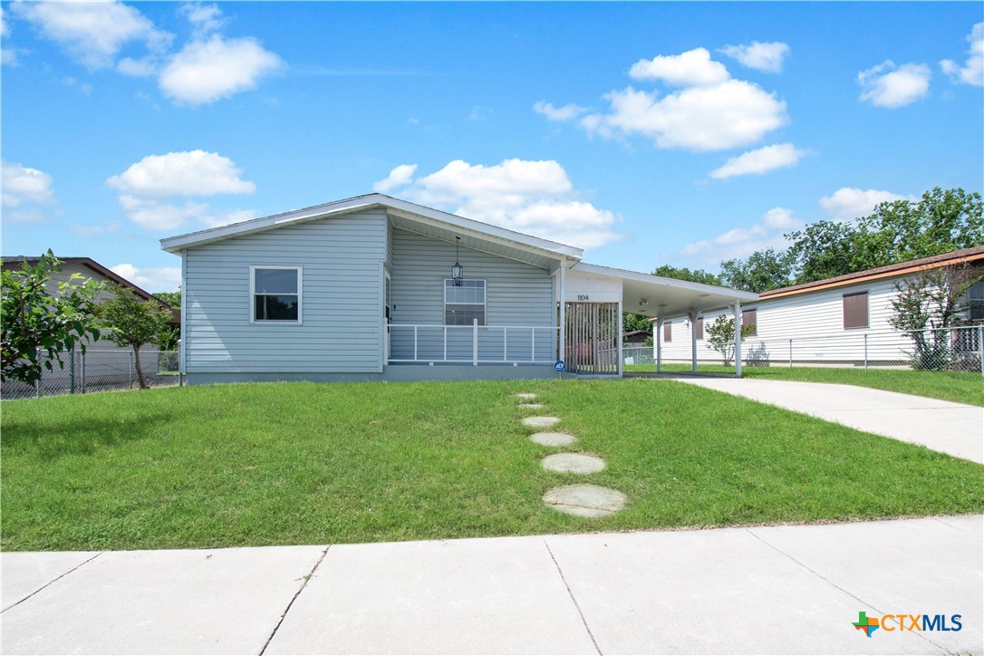 a front view of house with yard and green space