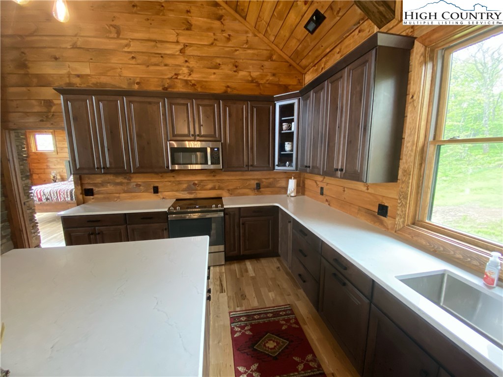 543 Broken Arrow Trail Boone, NC 28607 - Photo 18 of 35 a kitchen with stainless steel appliances a stove sink and a microwave