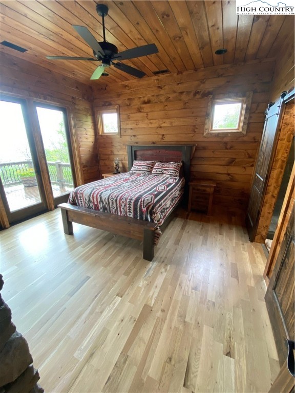 543 Broken Arrow Trail Boone, NC 28607 - Photo 22 of 35 a spacious bedroom with a bed wooden floor and window