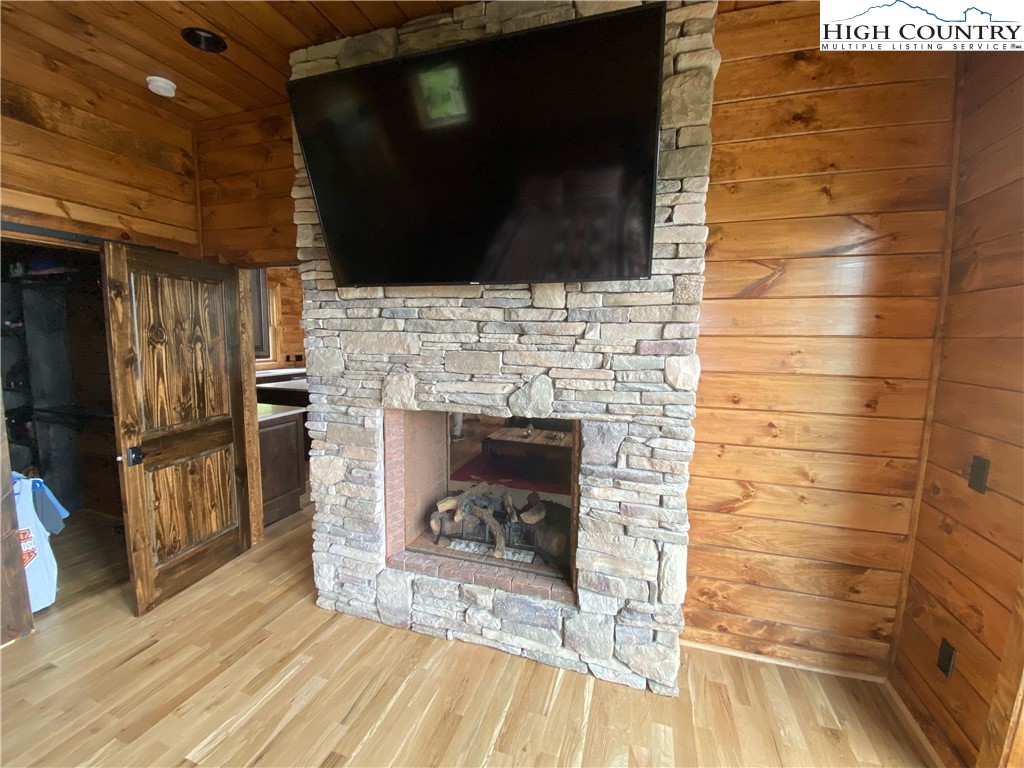 543 Broken Arrow Trail Boone, NC 28607 - Photo 28 of 35 a living room with stainless steel appliances wooden floor and a fireplace