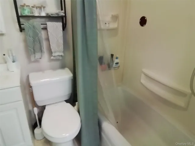 a white toilet sitting next to a bathroom sink