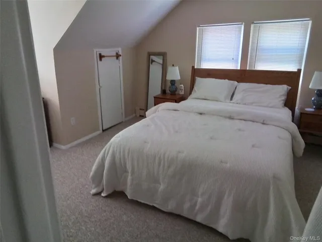 a bedroom with a bed and a mirror