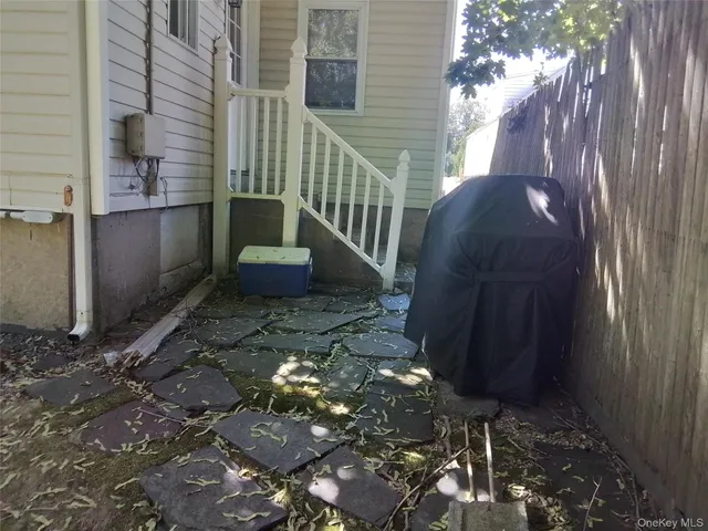 a view of a porch with chairs and potted plants
