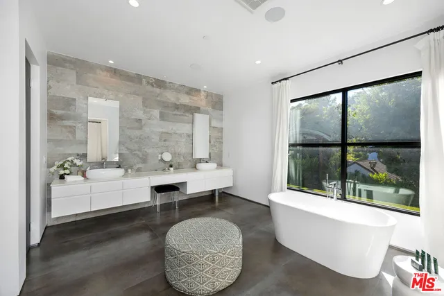 a living room with large window and a table