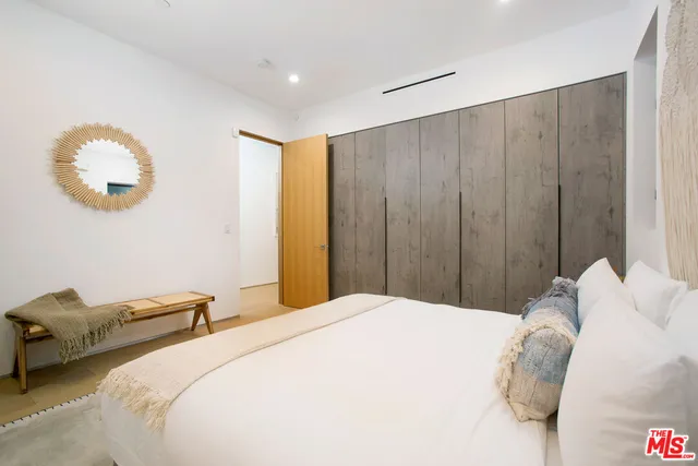 a bedroom with bed and a chandelier