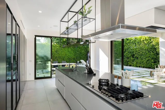 a kitchen with a stove a sink and cabinets