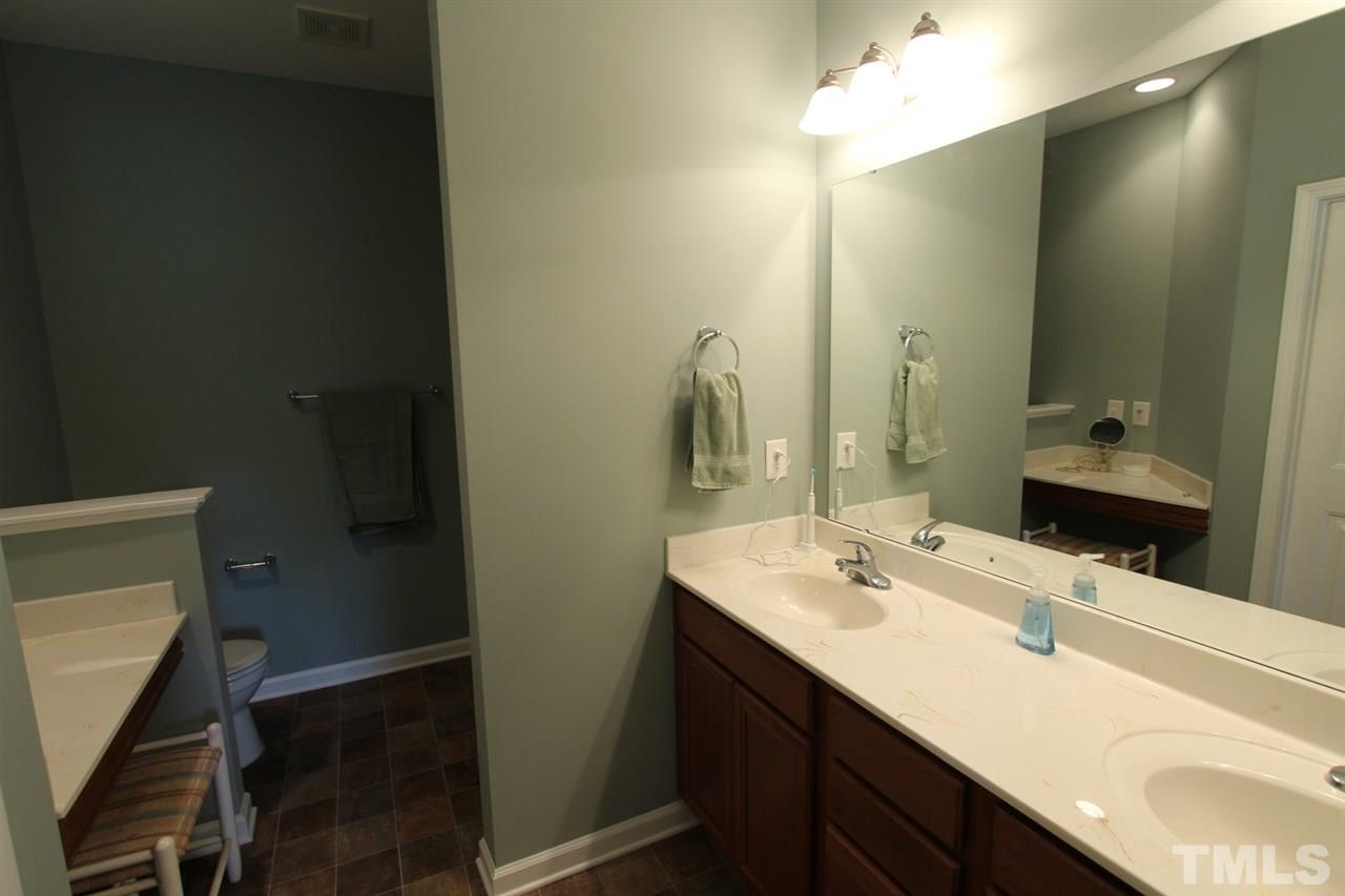 6312 Slopeside Court Raleigh, NC 27610 - Photo 13 of 22 a bathroom with a sink and a mirror