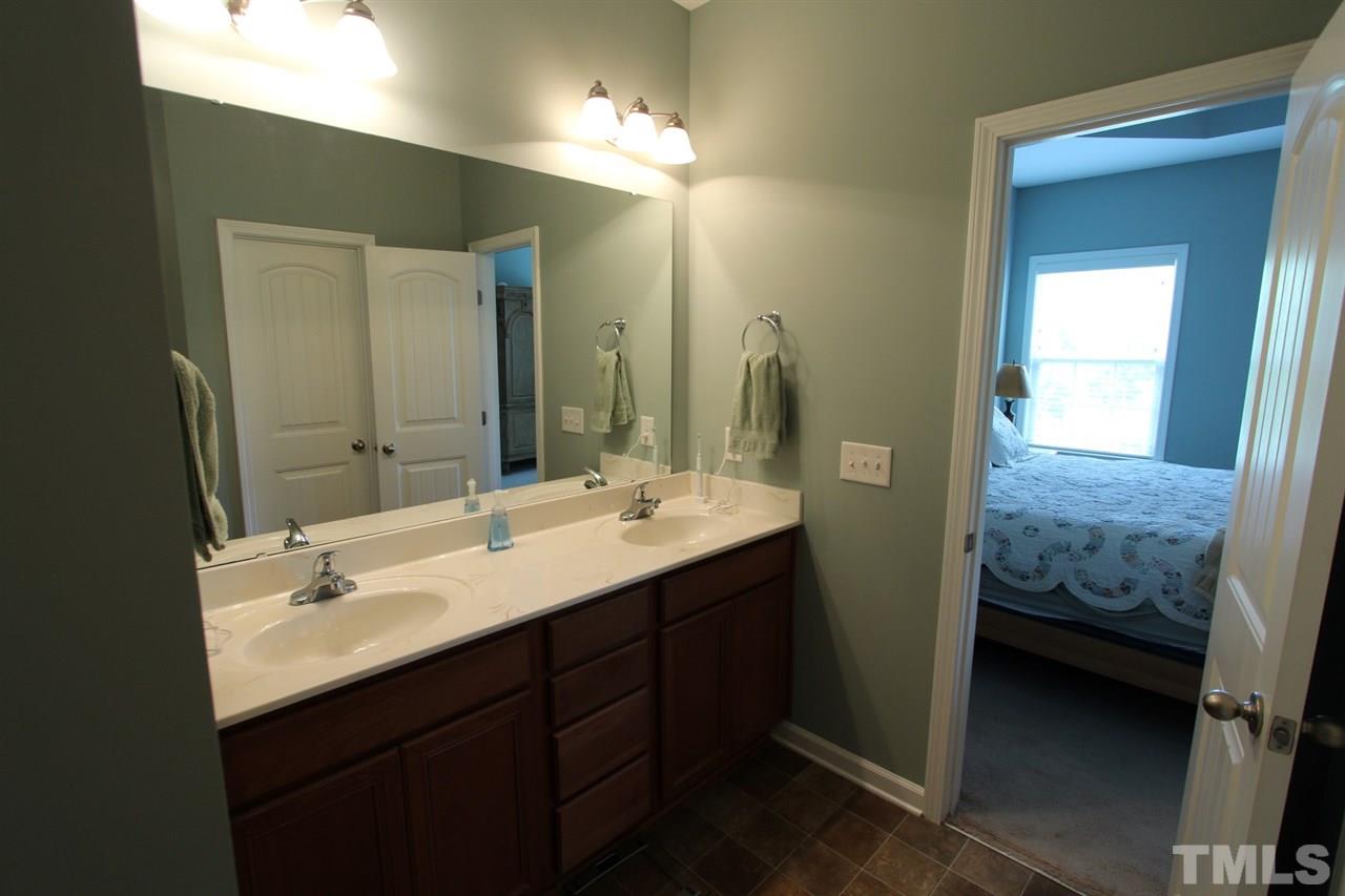 6312 Slopeside Court Raleigh, NC 27610 - Photo 14 of 22 a en suite bathroom with double sink and a mirror