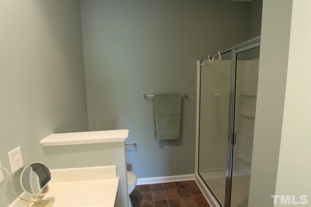 6312 Slopeside Court Raleigh, NC 27610 - Photo 15 of 22 a bathroom with a toilet and a shower
