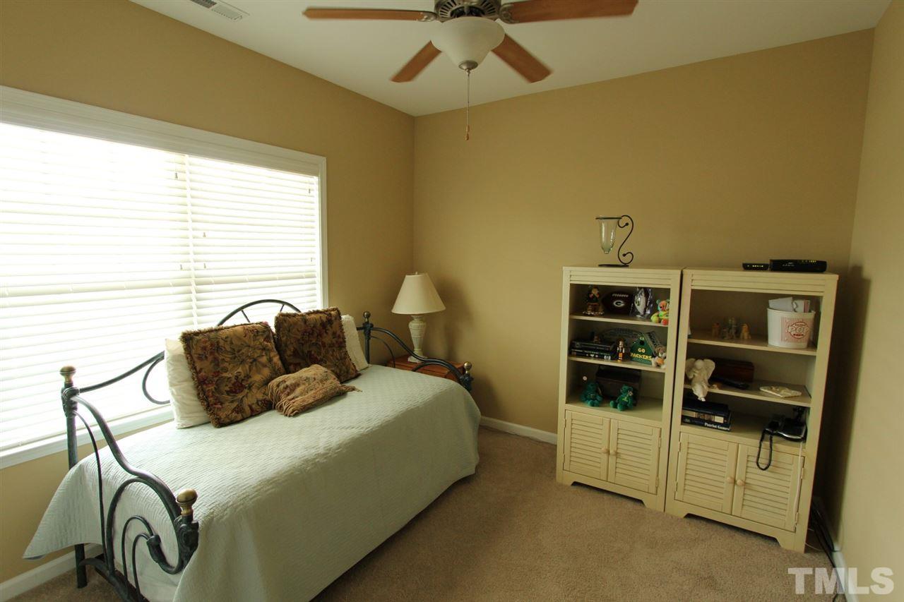 6312 Slopeside Court Raleigh, NC 27610 - Photo 16 of 22 a bedroom with a bed and a window