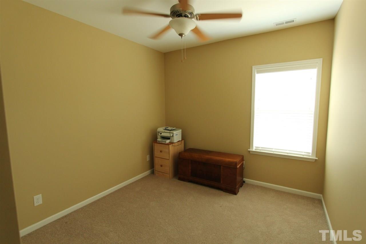 6312 Slopeside Court Raleigh, NC 27610 - Photo 17 of 22 an empty room with a window and a ceiling fan