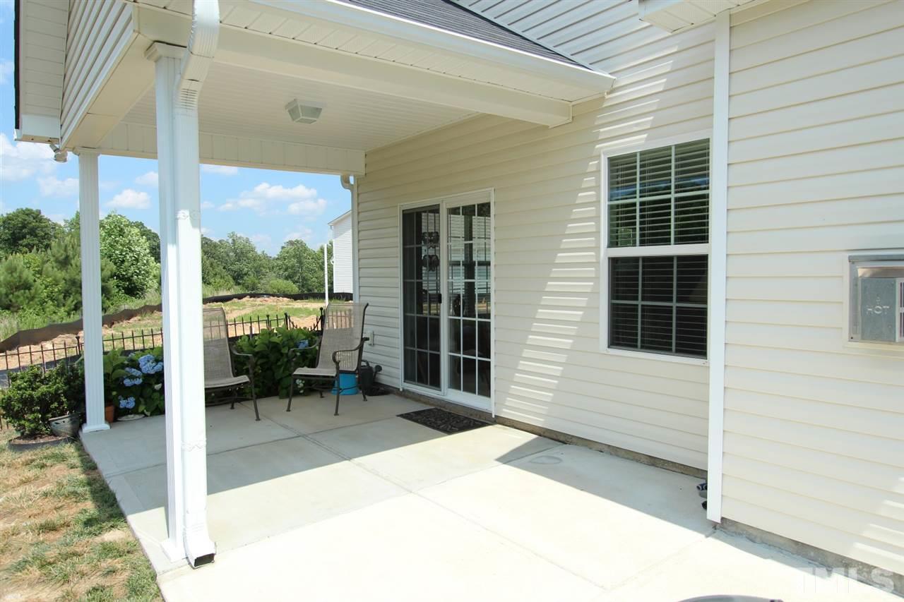 6312 Slopeside Court Raleigh, NC 27610 - Photo 19 of 22 a balcony with table and chairs