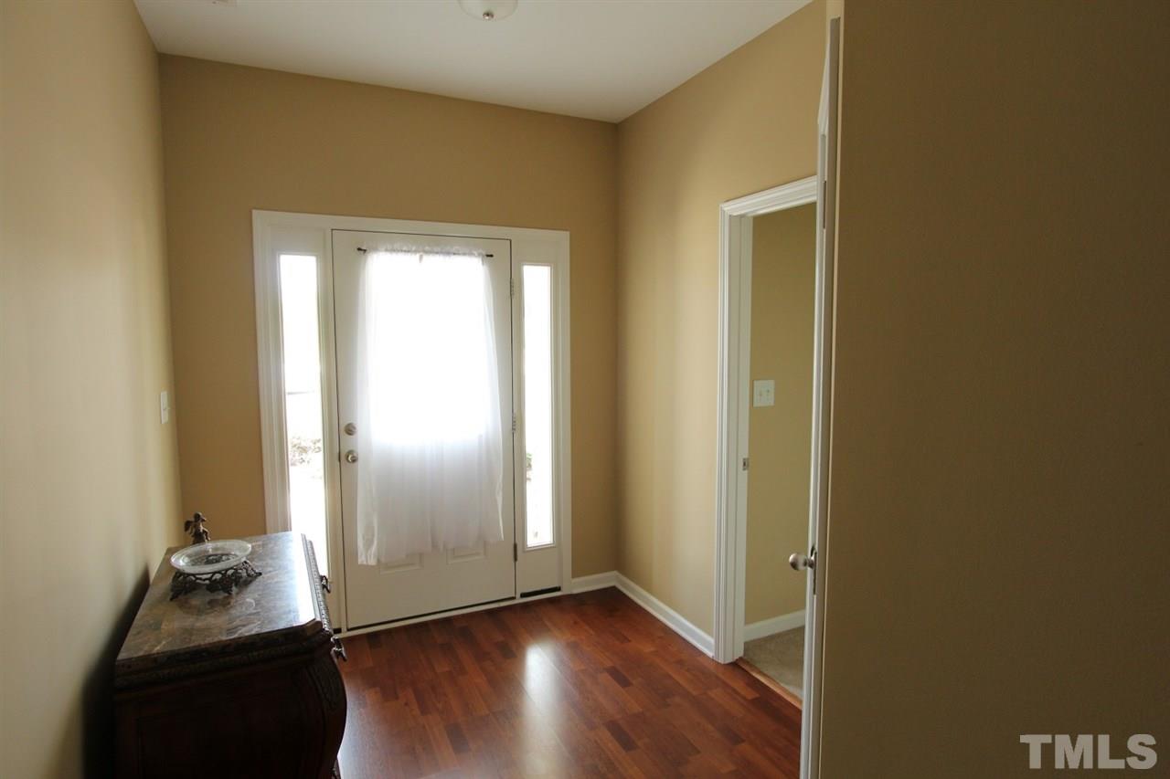 6312 Slopeside Court Raleigh, NC 27610 - Photo 3 of 22 an empty room with wooden floor and closet