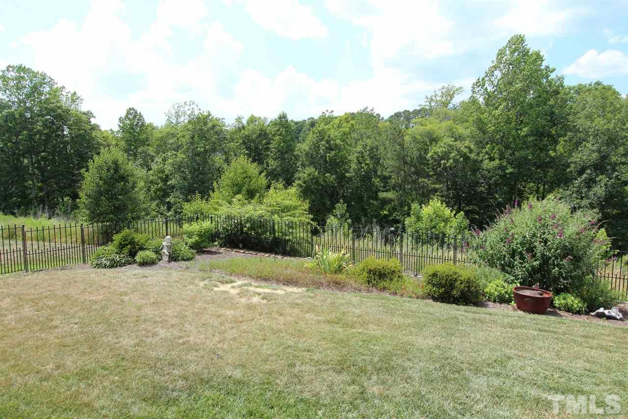 6312 Slopeside Court Raleigh, NC 27610 - Photo 22 of 22 a view of a field with trees in the background