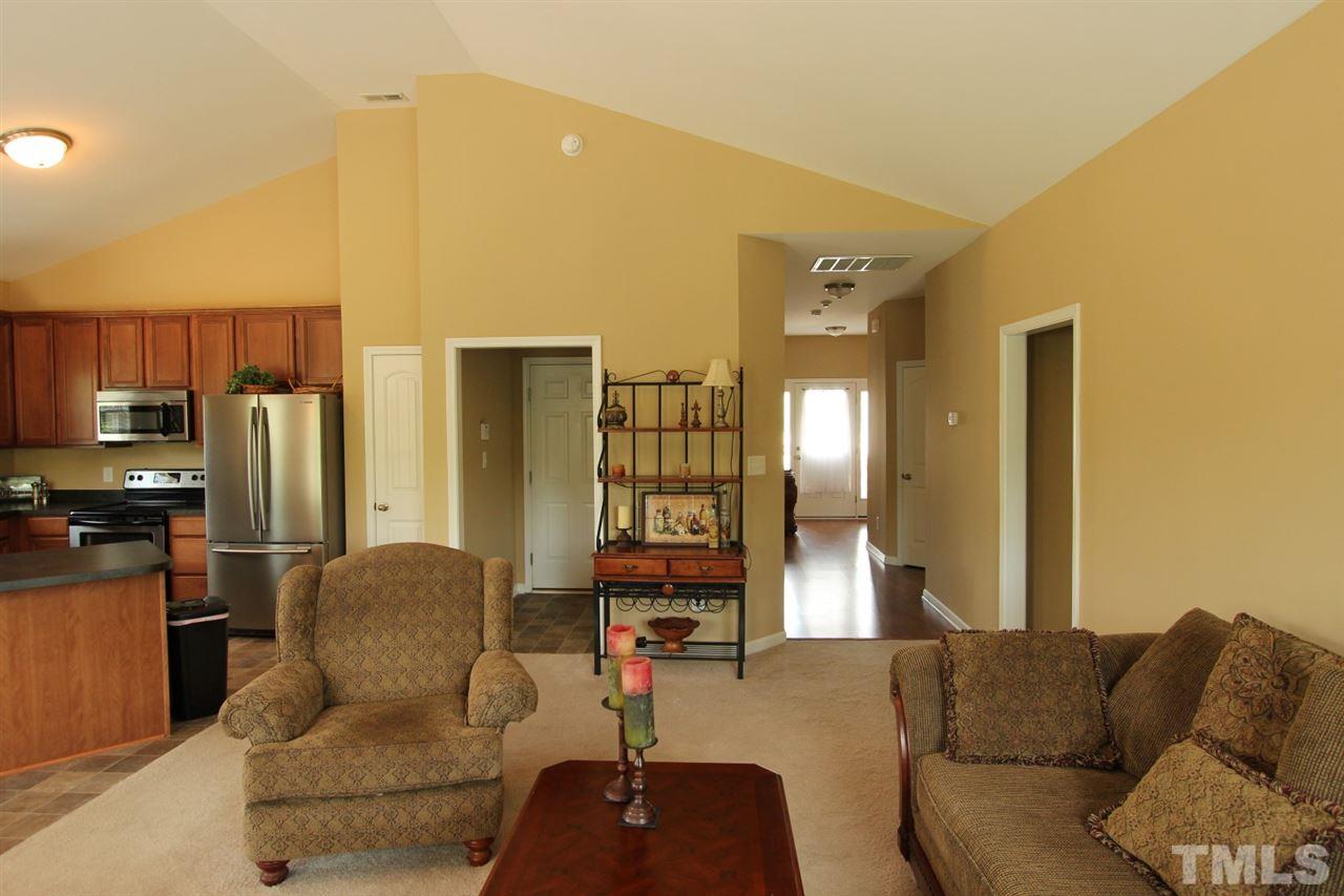 6312 Slopeside Court Raleigh, NC 27610 - Photo 9 of 22 a living room with furniture and kitchen view