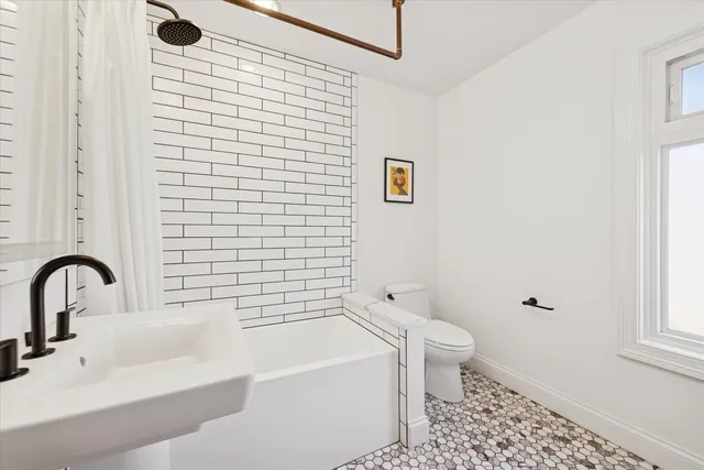 a bathroom with a sink a mirror and a shower