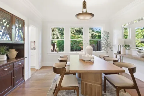 a view of a dining room with furniture window and outside view