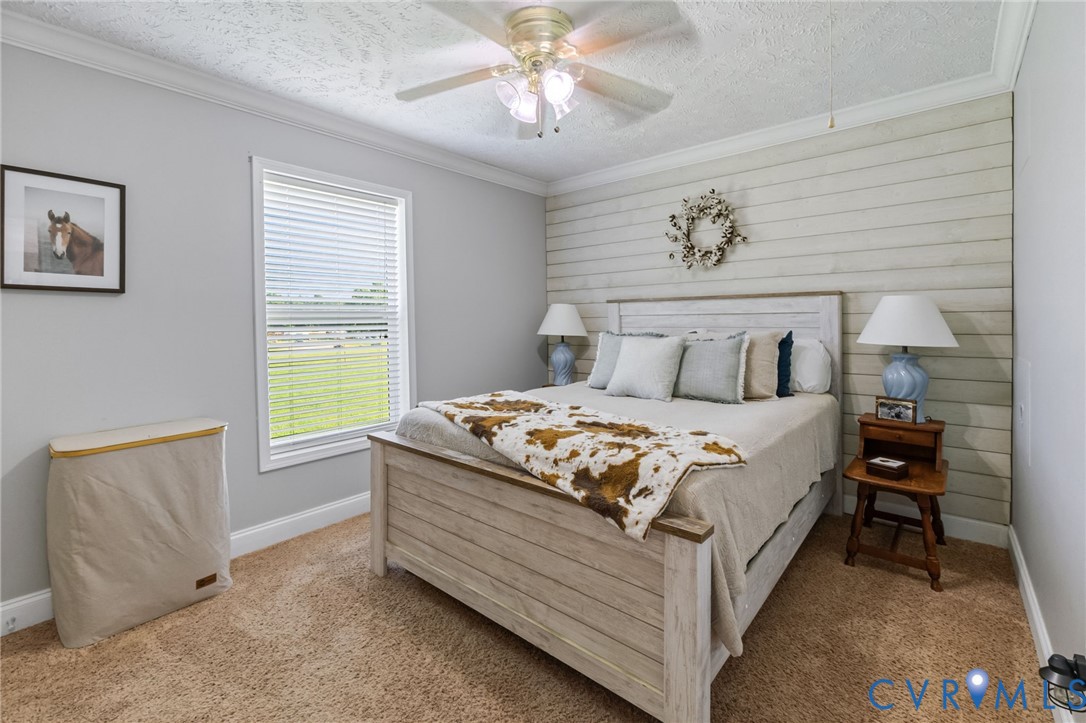 10910 Courthouse Road Dinwiddie, VA 23841 - Photo 14 of 38 Shiplap accent wall, crown molding, ceiling fan wi