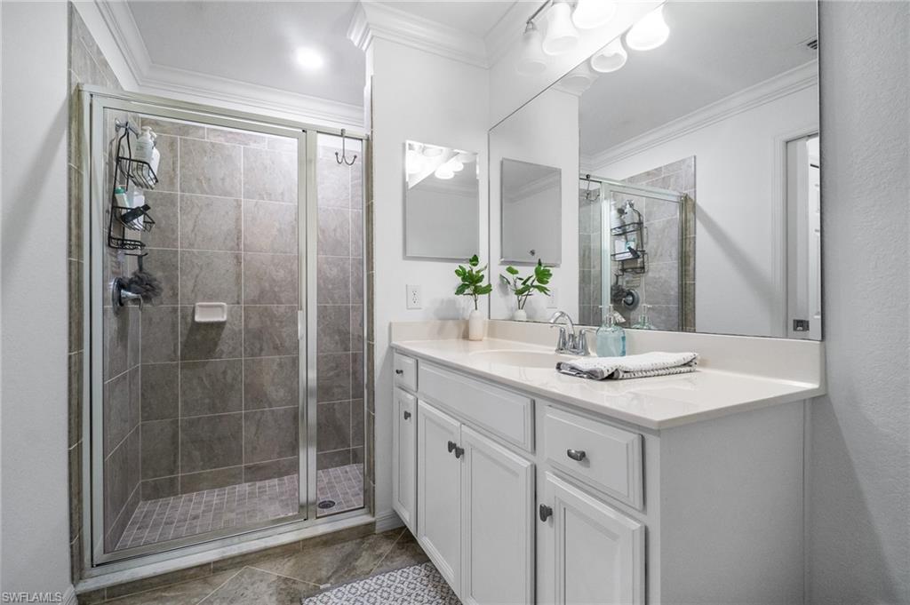 9596 Trevi Court, Unit 5413 Naples, FL 34113 - Photo 11 of 26 a bathroom with a shower sink and mirror