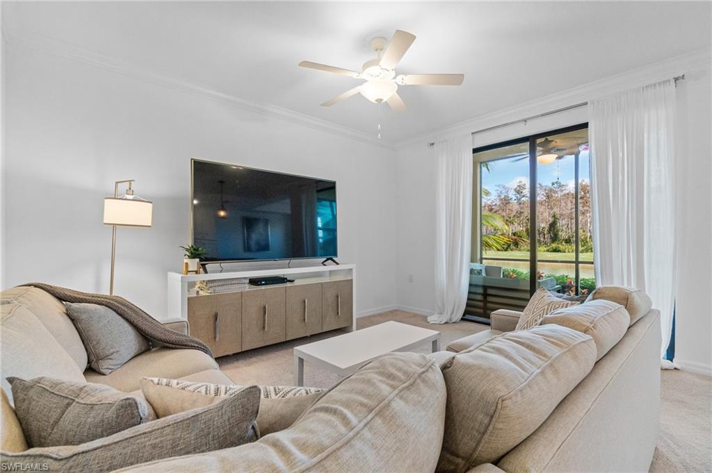 9596 Trevi Court, Unit 5413 Naples, FL 34113 - Photo 2 of 26 a living room with furniture and a flat screen tv