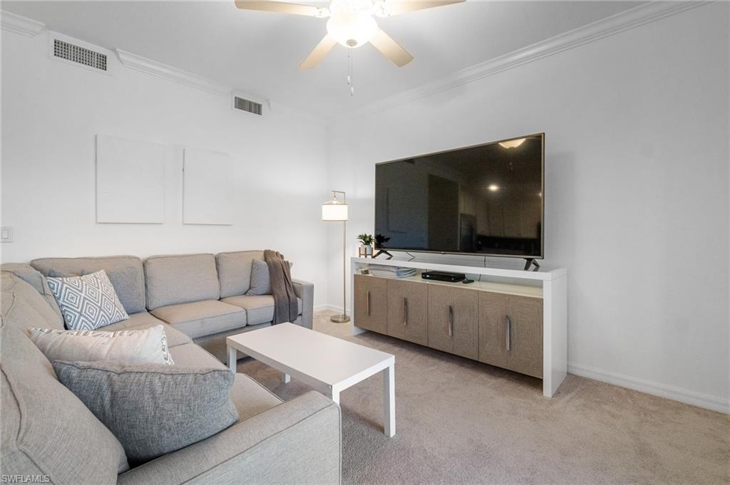 9596 Trevi Court, Unit 5413 Naples, FL 34113 - Photo 3 of 26 a living room with furniture and a flat screen tv