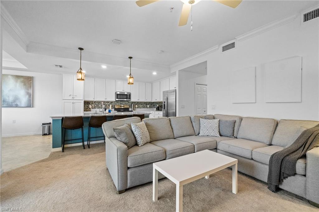 9596 Trevi Court, Unit 5413 Naples, FL 34113 - Photo 4 of 26 a living room with furniture and kitchen view