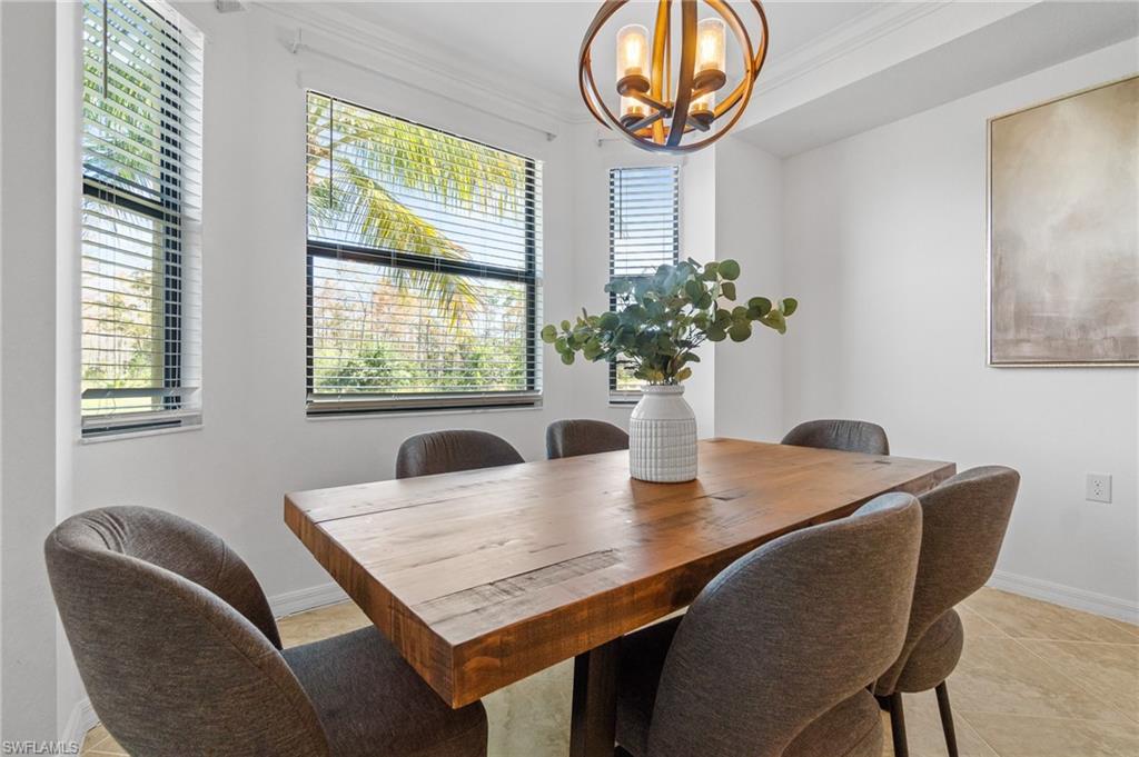 9596 Trevi Court, Unit 5413 Naples, FL 34113 - Photo 5 of 26 a view of a dining room with furniture and window