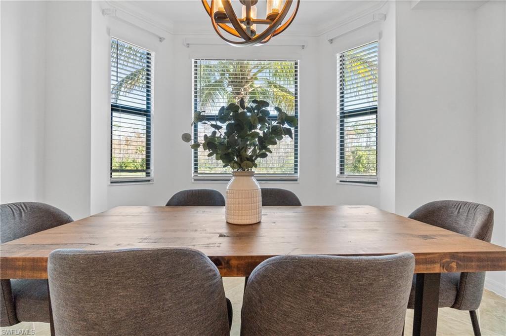 9596 Trevi Court, Unit 5413 Naples, FL 34113 - Photo 7 of 26 a view of a dining room with furniture and window