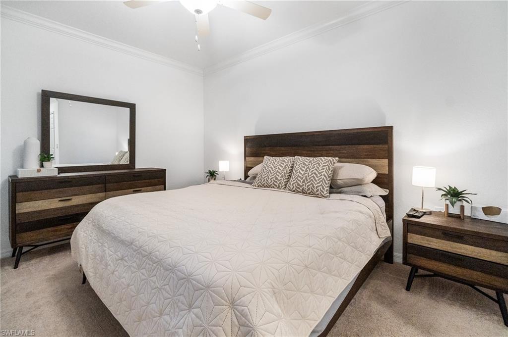 9596 Trevi Court, Unit 5413 Naples, FL 34113 - Photo 10 of 26 a bedroom with a bed and a dresser