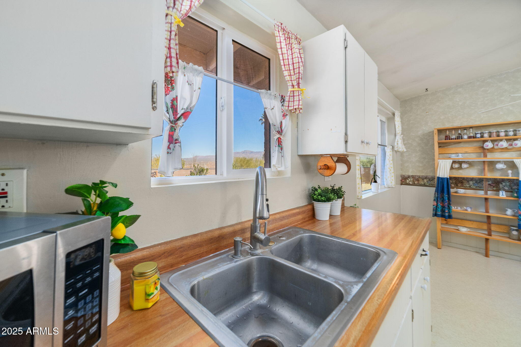 417 West Sunset Drive Mammoth, AZ 85618 - Photo 13 of 35 a kitchen with stainless steel appliances a sink a counter top space and cabinets