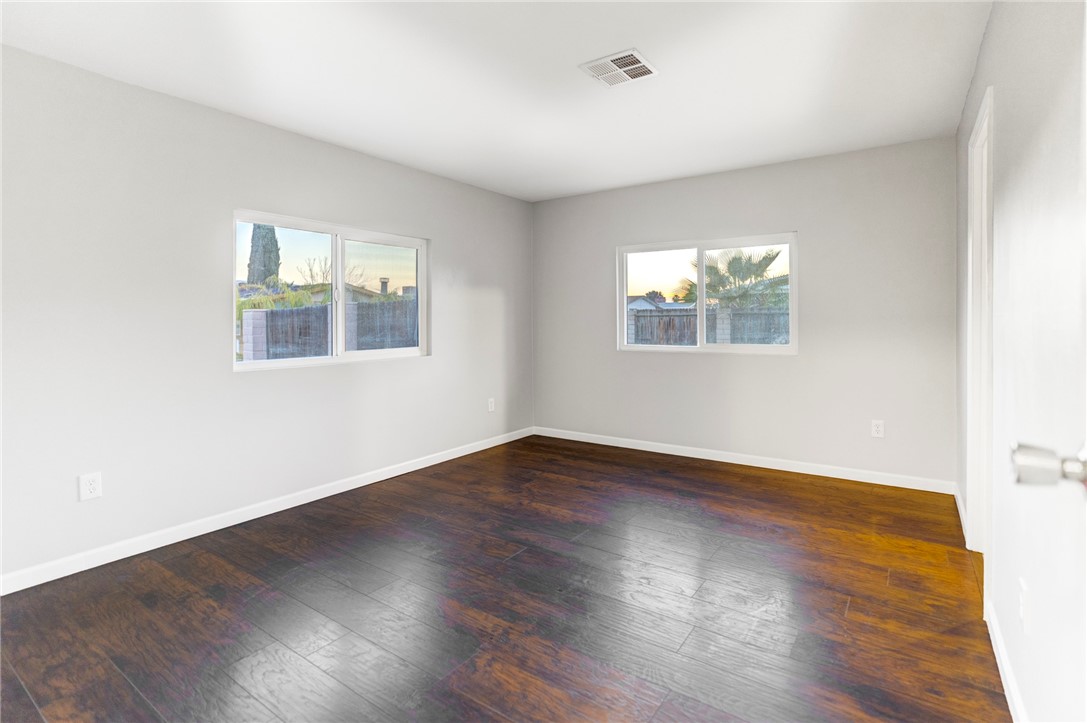 8536 Kern Canyon Road, Unit 184 Bakersfield, CA 93306 - Photo 12 of 28 an empty room with wooden floor and windows