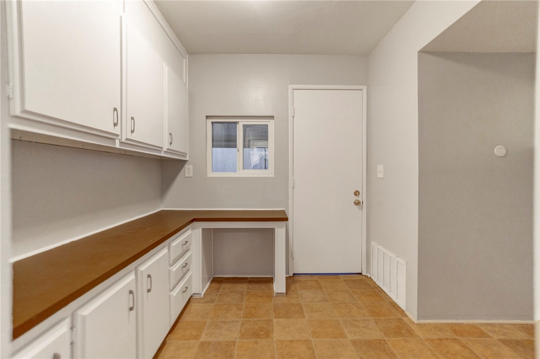 8536 Kern Canyon Road, Unit 184 Bakersfield, CA 93306 - Photo 18 of 28 a kitchen with granite countertop white cabinets and a sink