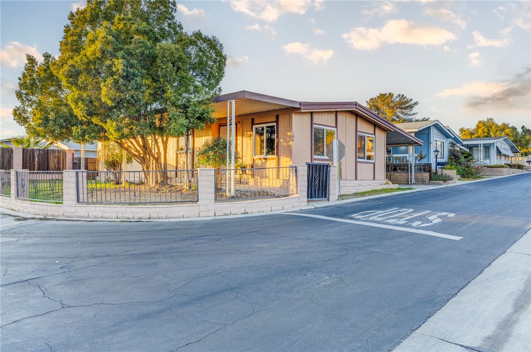 8536 Kern Canyon Road, Unit 184 Bakersfield, CA 93306 - Photo 22 of 28 a front view of a house with a trees