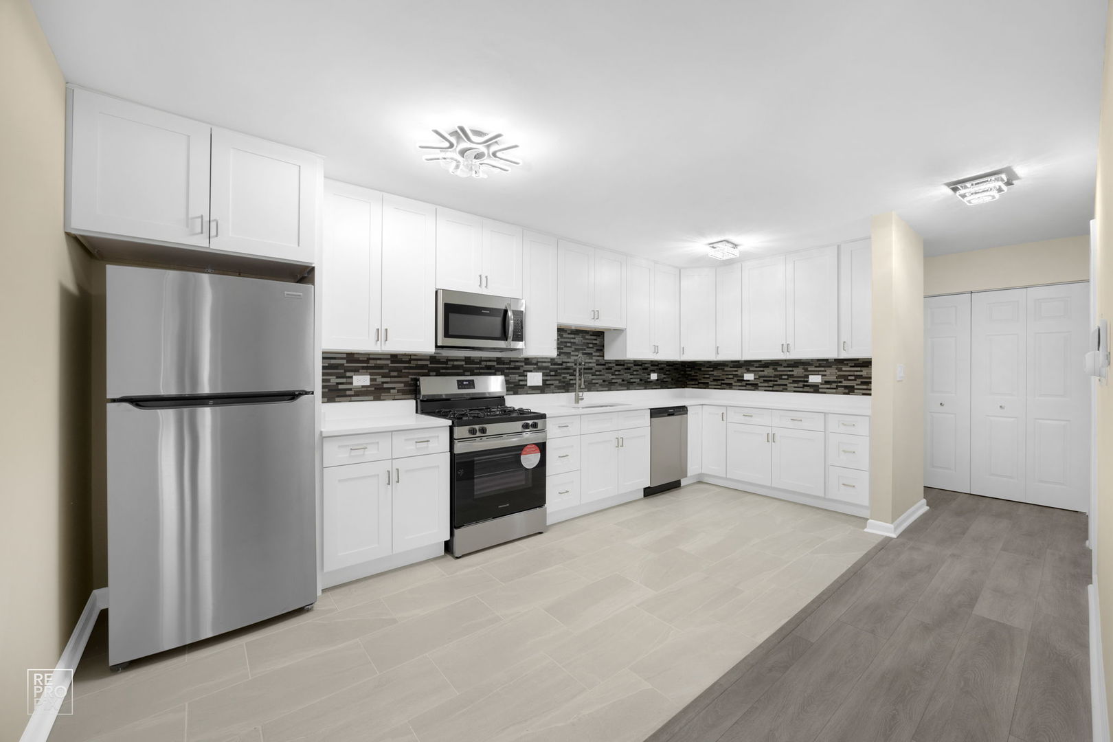 615 Hill Drive, Unit 103 Hoffman Estates, IL 60169 - Photo 2 of 10 a kitchen with white cabinets and white appliances