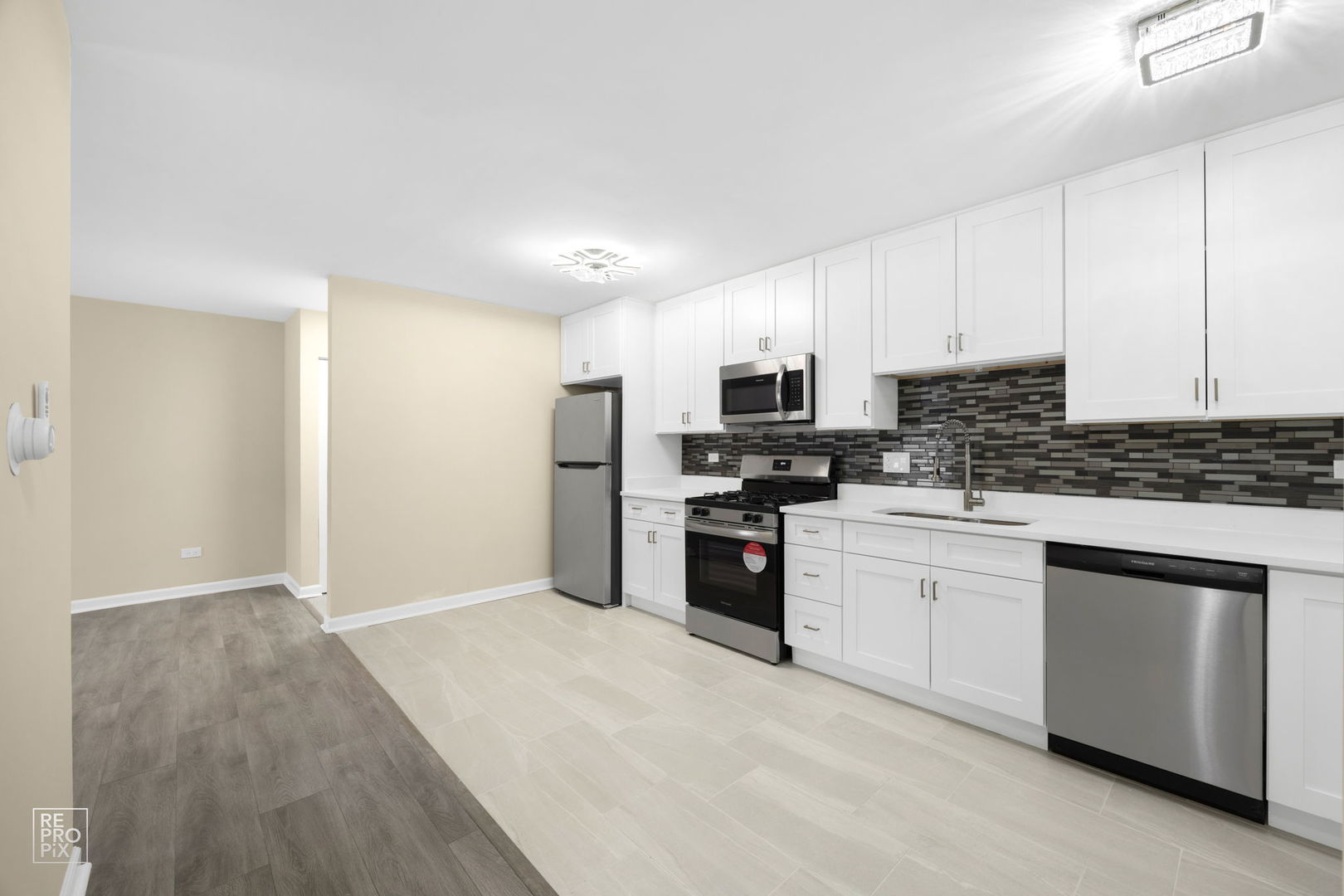 615 Hill Drive, Unit 103 Hoffman Estates, IL 60169 - Photo 3 of 10 a kitchen with stainless steel appliances a refrigerator stove microwave and sink