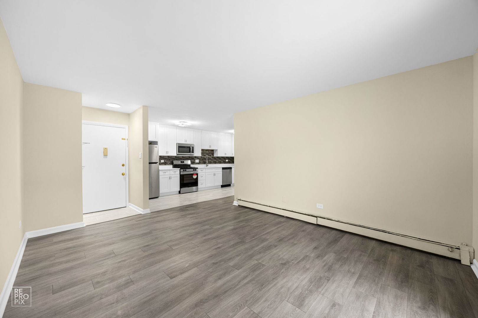 615 Hill Drive, Unit 103 Hoffman Estates, IL 60169 - Photo 5 of 10 a view of a kitchen with a sink and a refrigerator