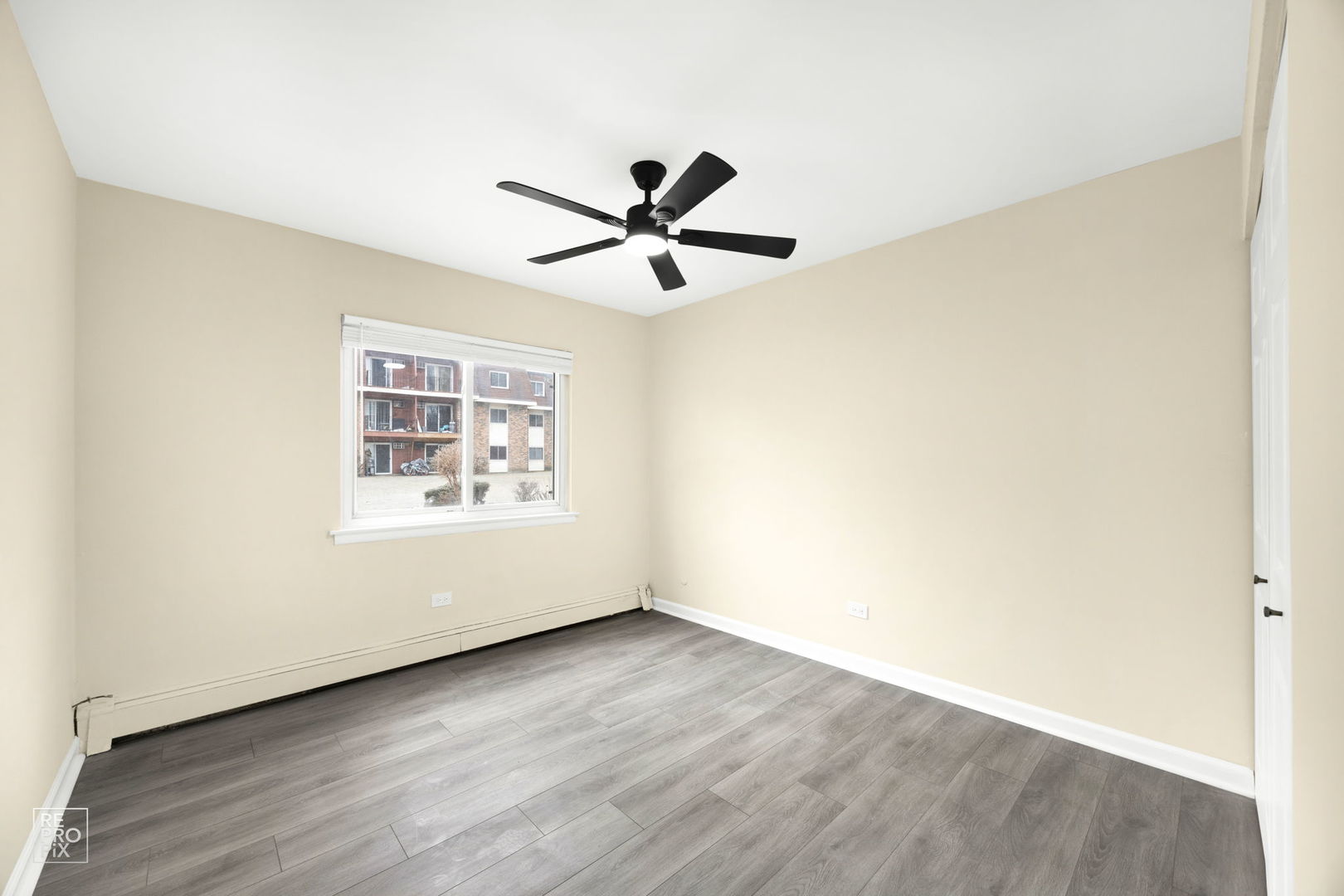 615 Hill Drive, Unit 103 Hoffman Estates, IL 60169 - Photo 8 of 10 a view of a room with wooden floor and a ceiling fan