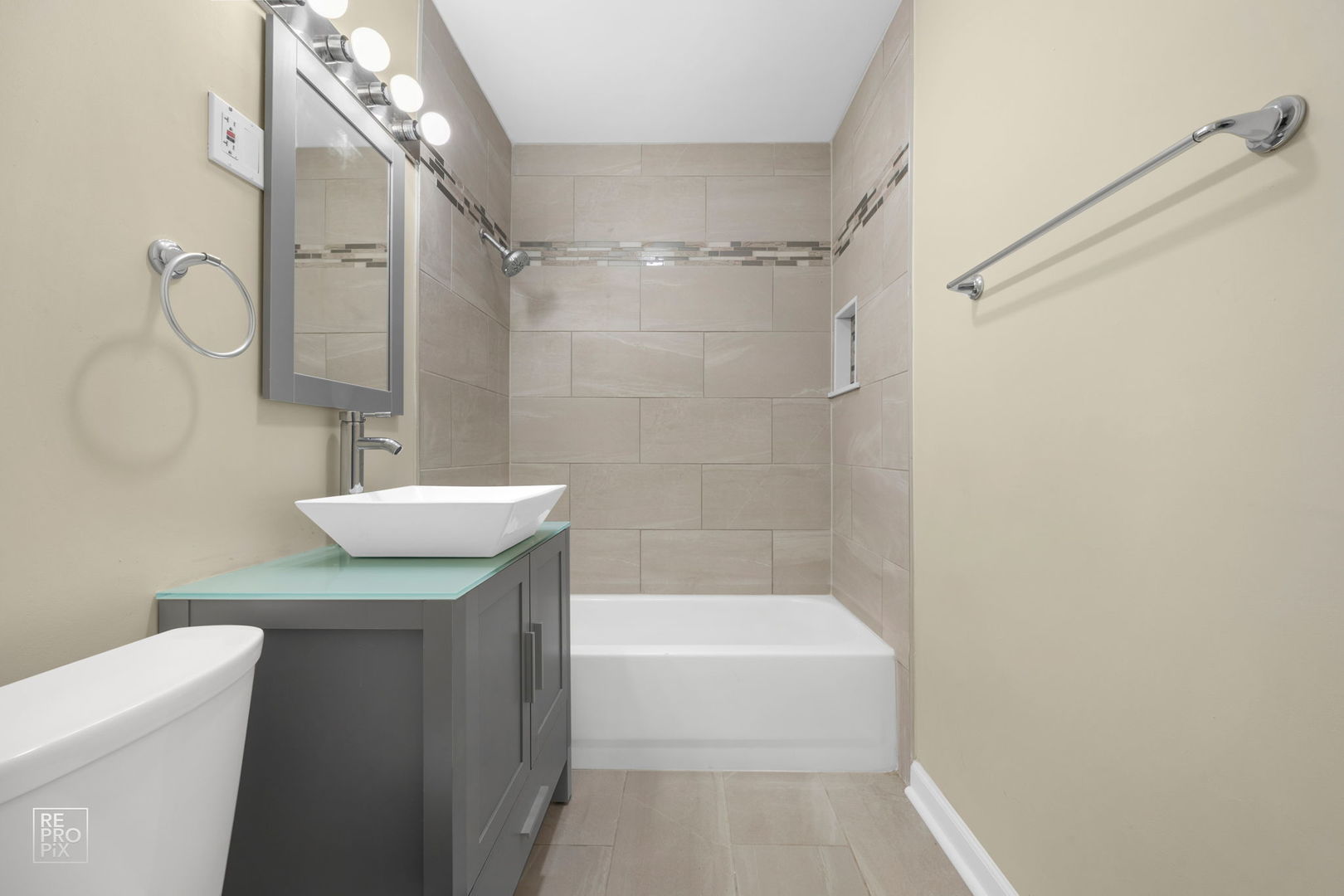 615 Hill Drive, Unit 103 Hoffman Estates, IL 60169 - Photo 9 of 10 a bathroom with a granite countertop sink a mirror and a bathtub