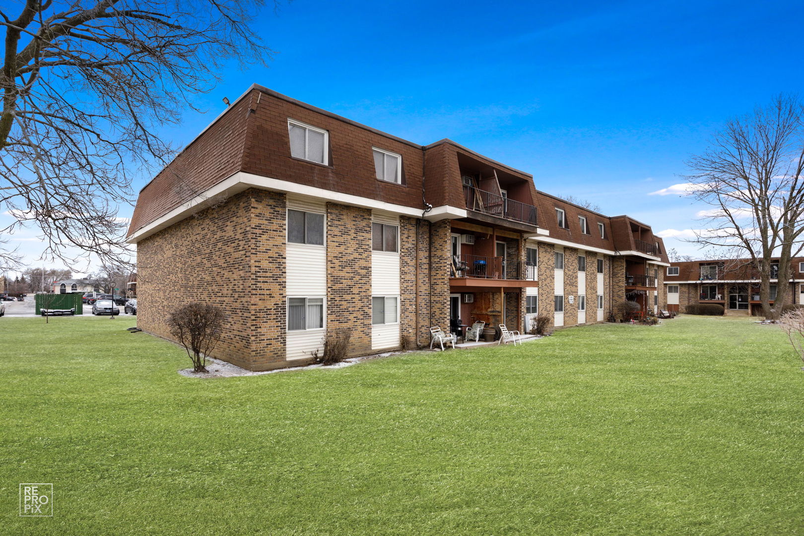 615 Hill Drive, Unit 103 Hoffman Estates, IL 60169 - Photo 10 of 10 a view of a house with a yard