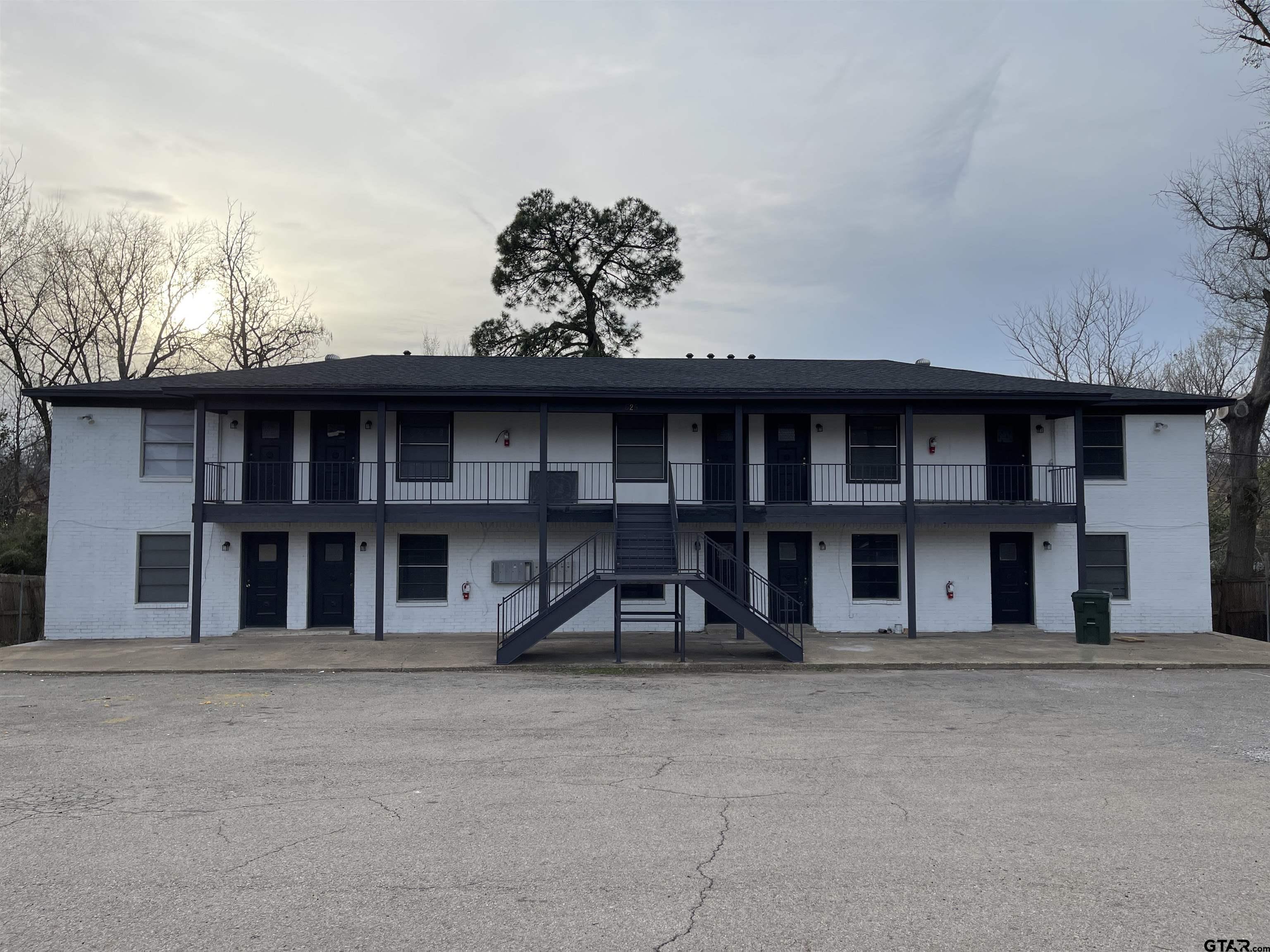 625 Augusta Avenue, Unit 10 Tyler, TX 75701 - Photo 1 of 9 a front view of a residential apartment building with a yard