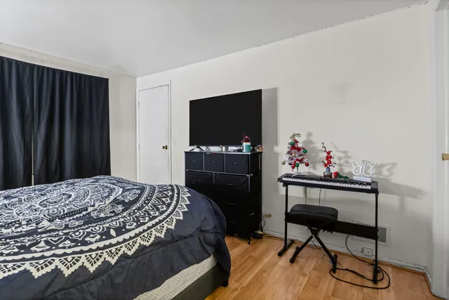 a bedroom with a bed and a flat screen tv