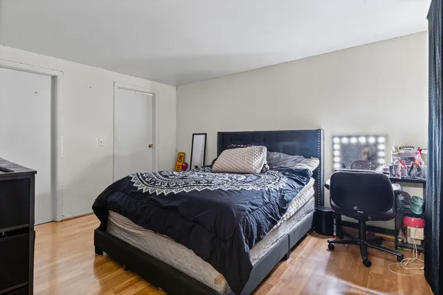 a bedroom with a bed chair and a window