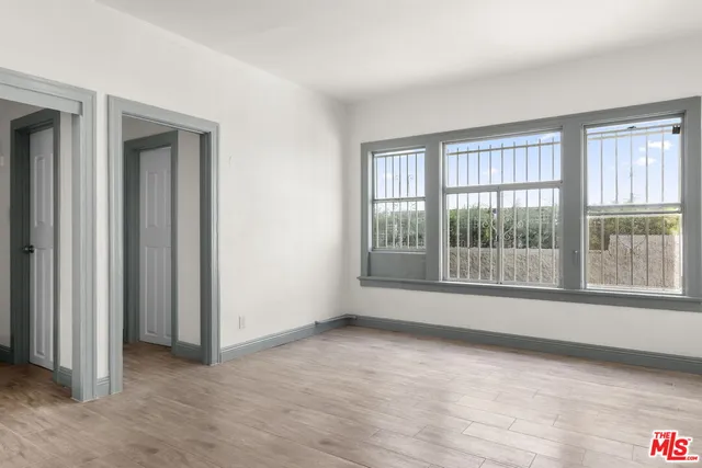 a bathroom with a sink and mirror with window