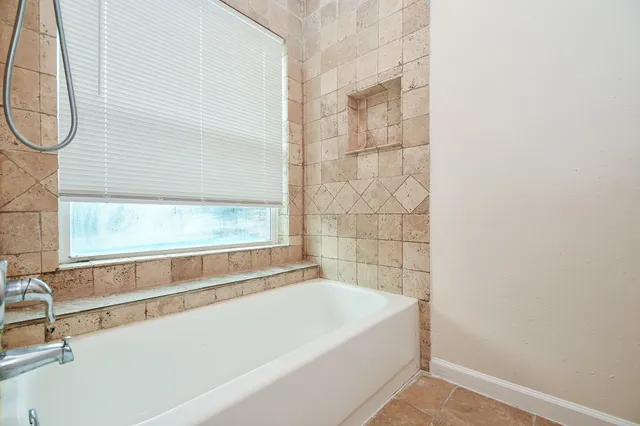a bathroom with a bathtub and shower