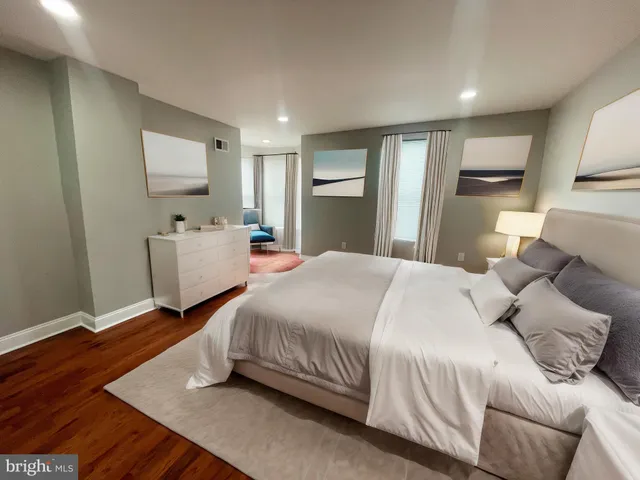 a bedroom with a bed and a dresser