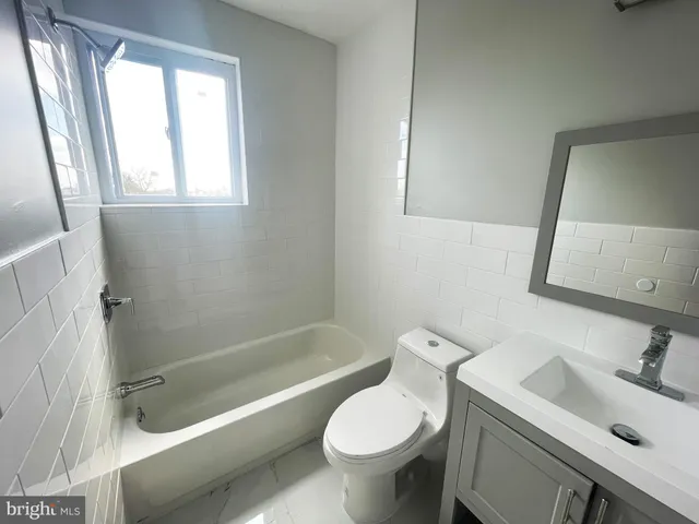 a bathroom with a sink toilet and bathtub