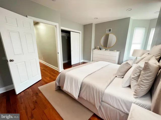 a bedroom with a bed and a mirror