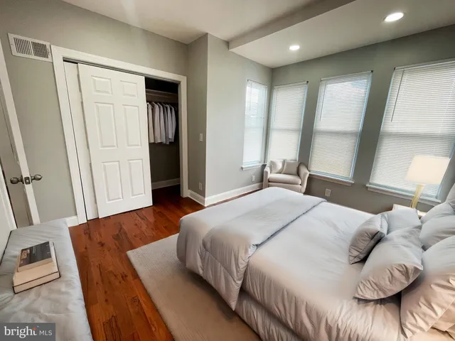 a bedroom with a bed and a large mirror